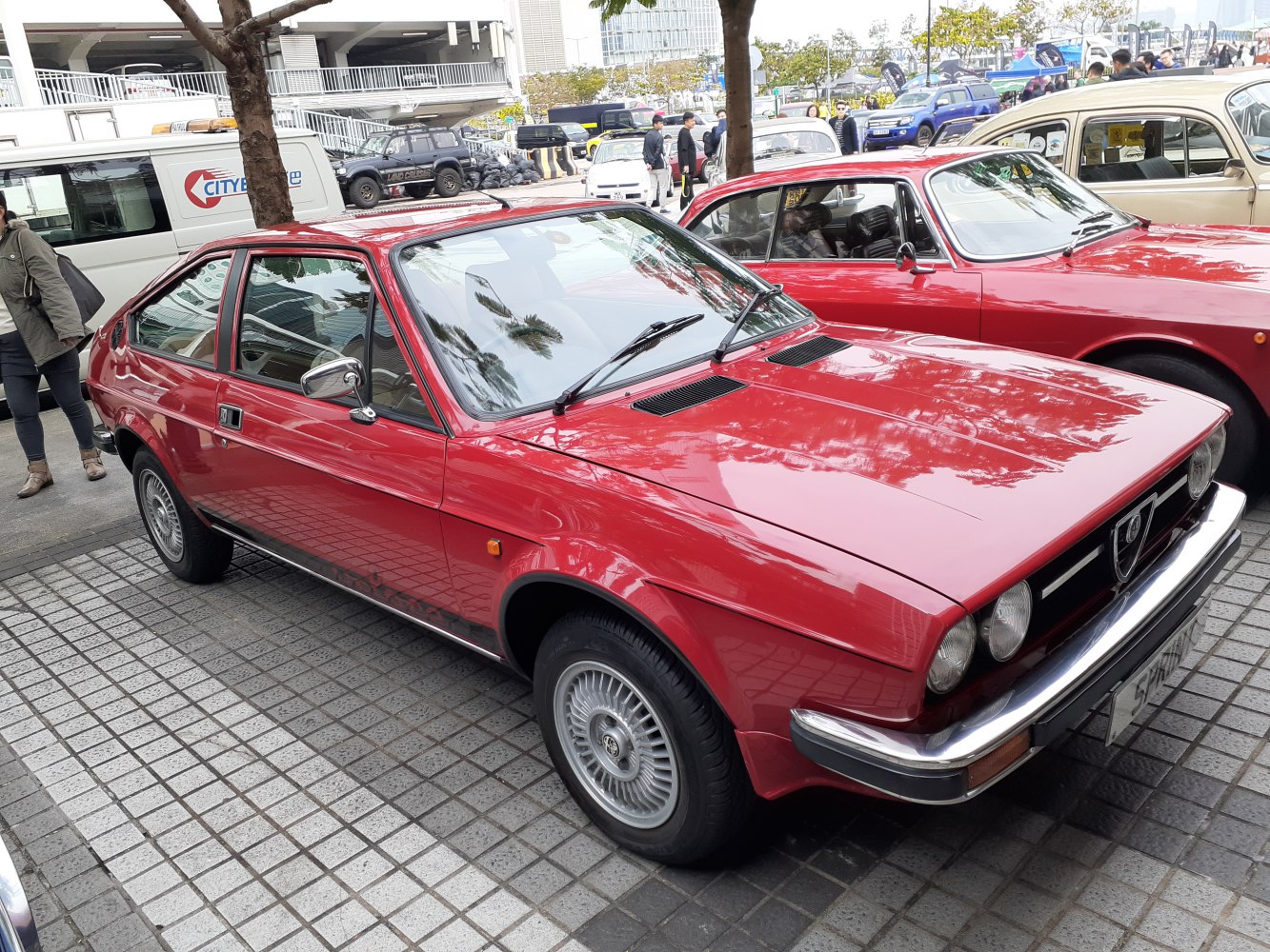 Red two-door coupe with quad headlights and sleek hatchback profile