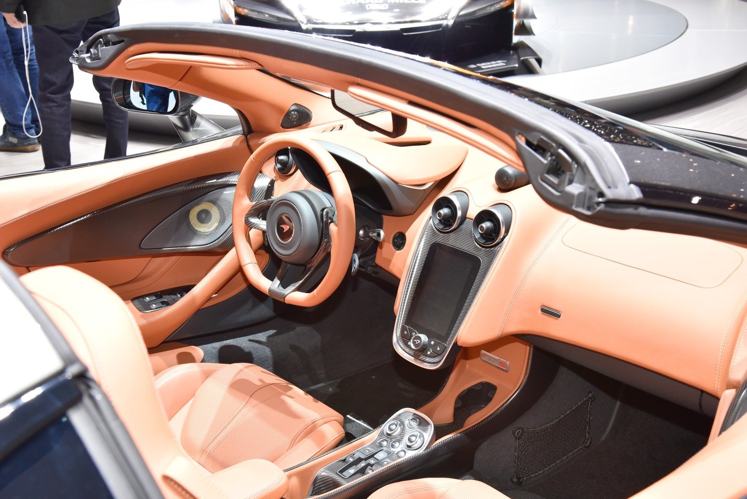Tan leather luxury interior with carbon fiber trim and advanced controls