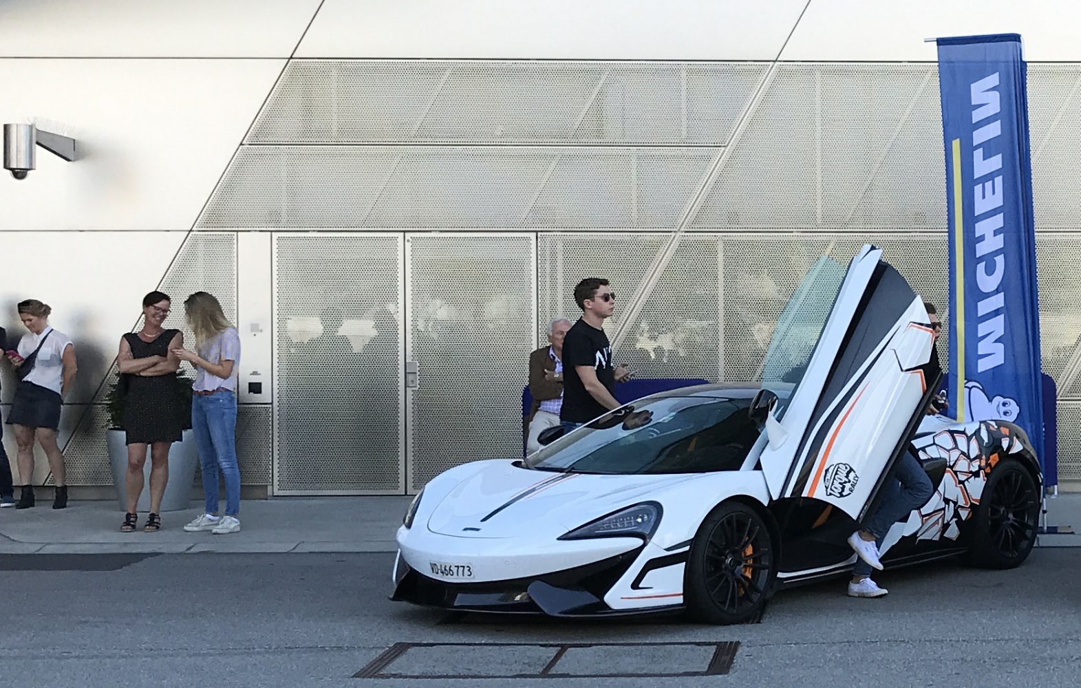 Butterfly door sports car with custom side graphics and aerodynamic design
