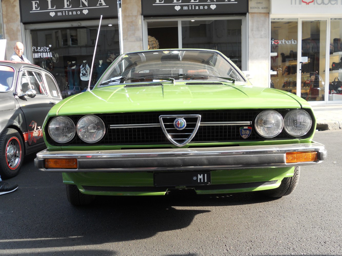 Front view with quad headlights and Alfa Romeo triangular grille.
