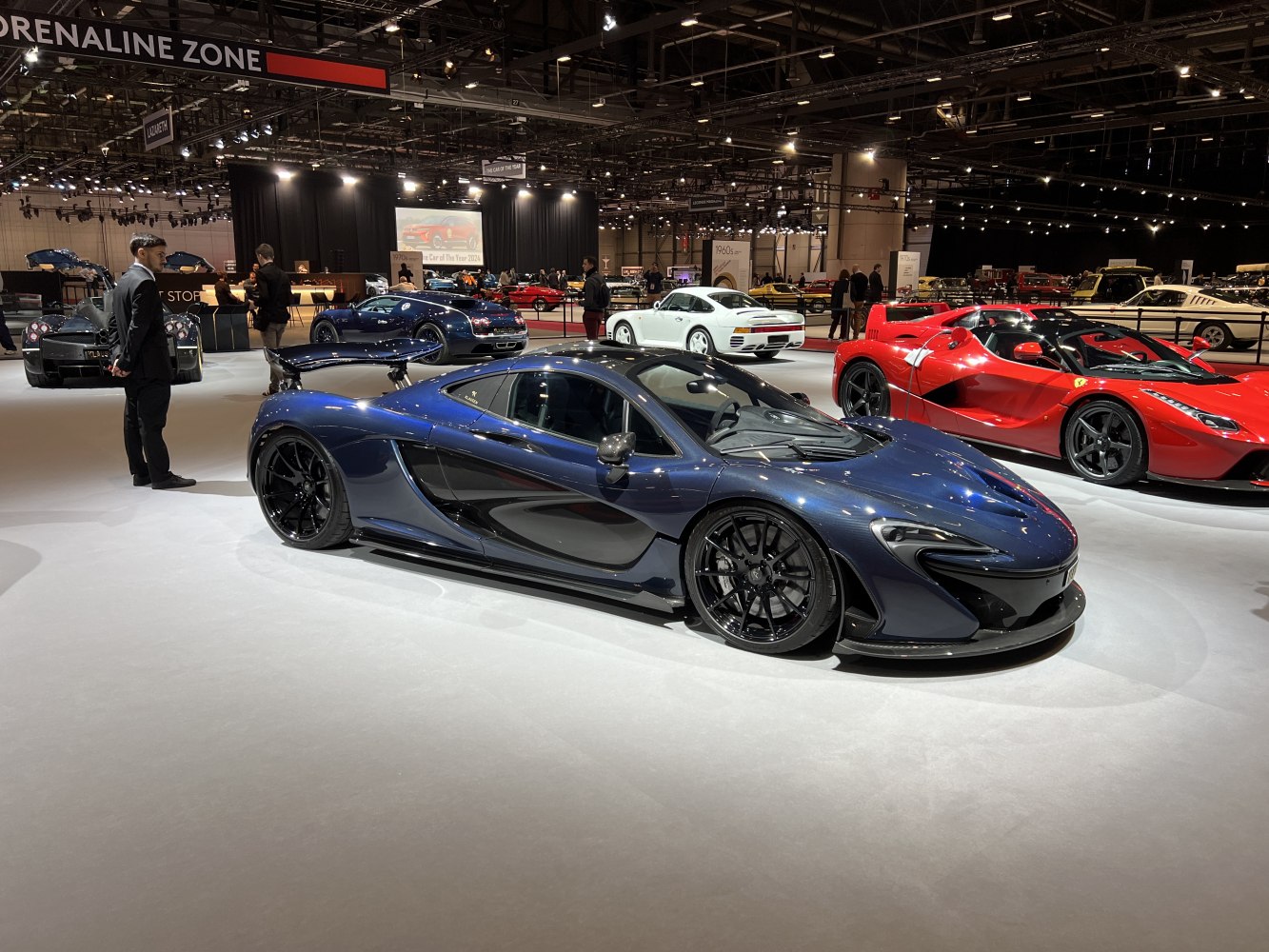 Sleek aerodynamic sports coupe with large rear wing and dark blue paint