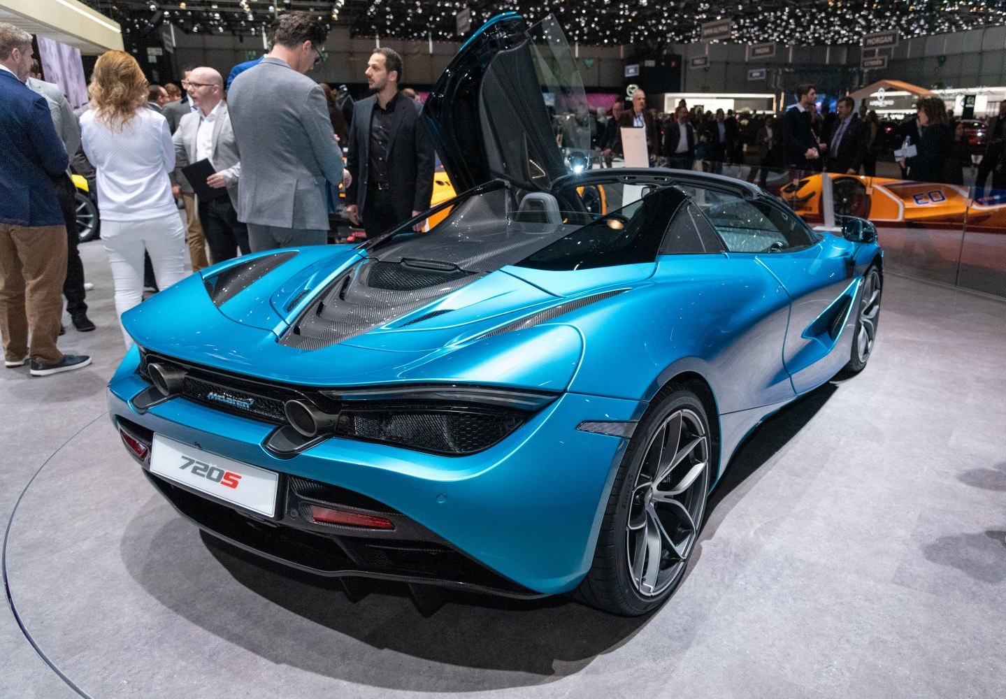 Rear and side view of blue convertible supercar with aerodynamic design