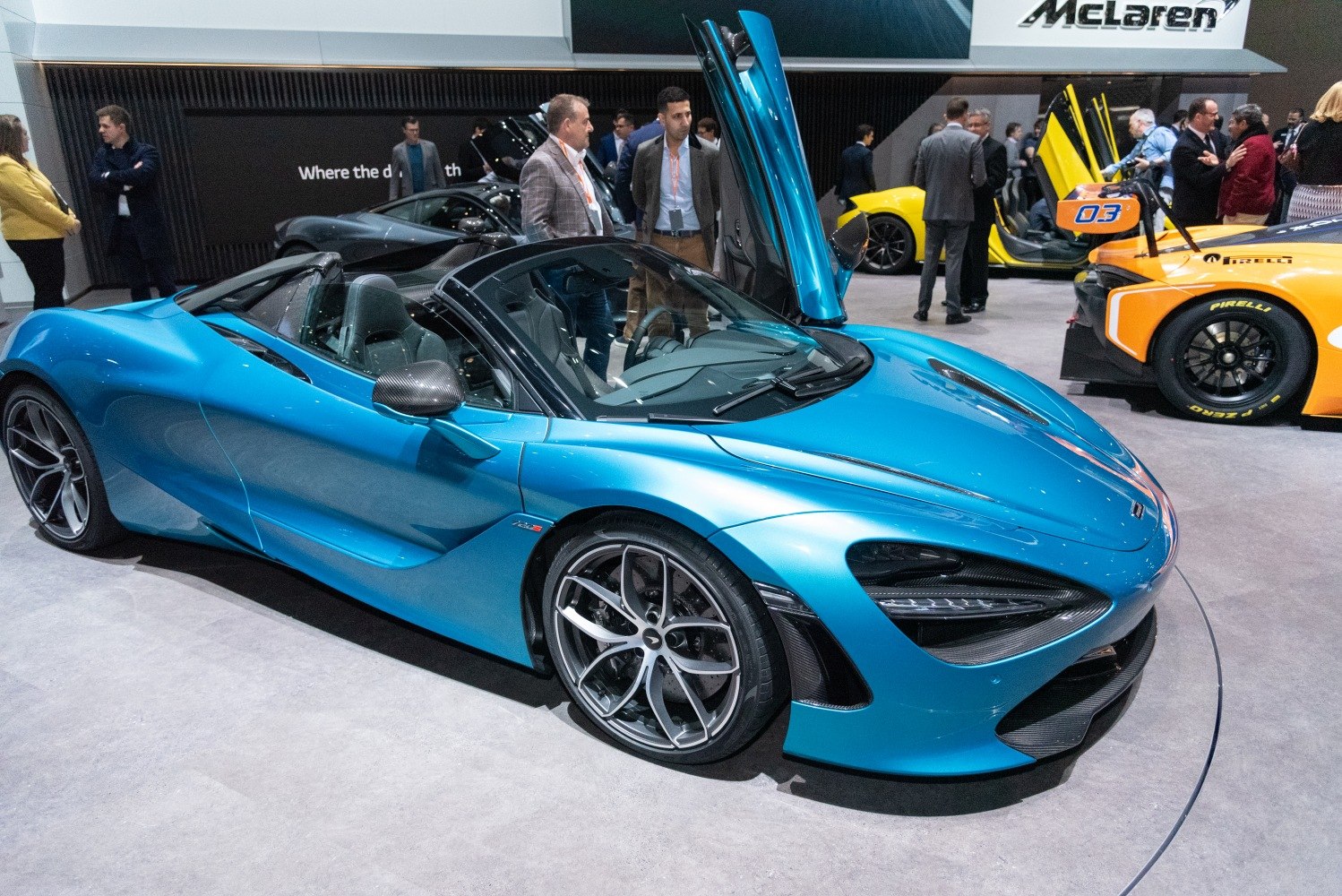 Blue convertible sports car with butterfly doors open