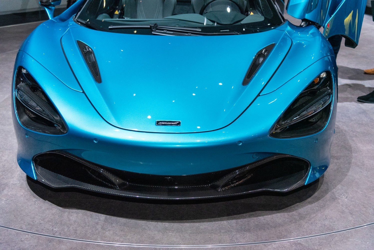 Close-up of aerodynamic front fascia with carbon fiber vents and distinctive headlights