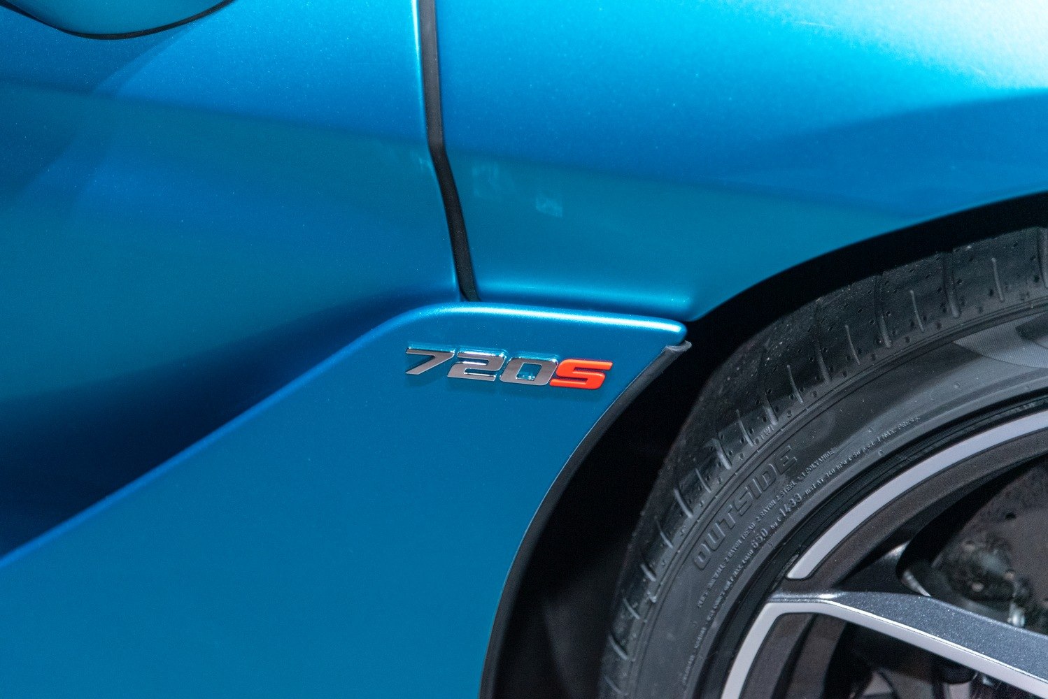 Close-up of a side badge and wheel with tire tread details