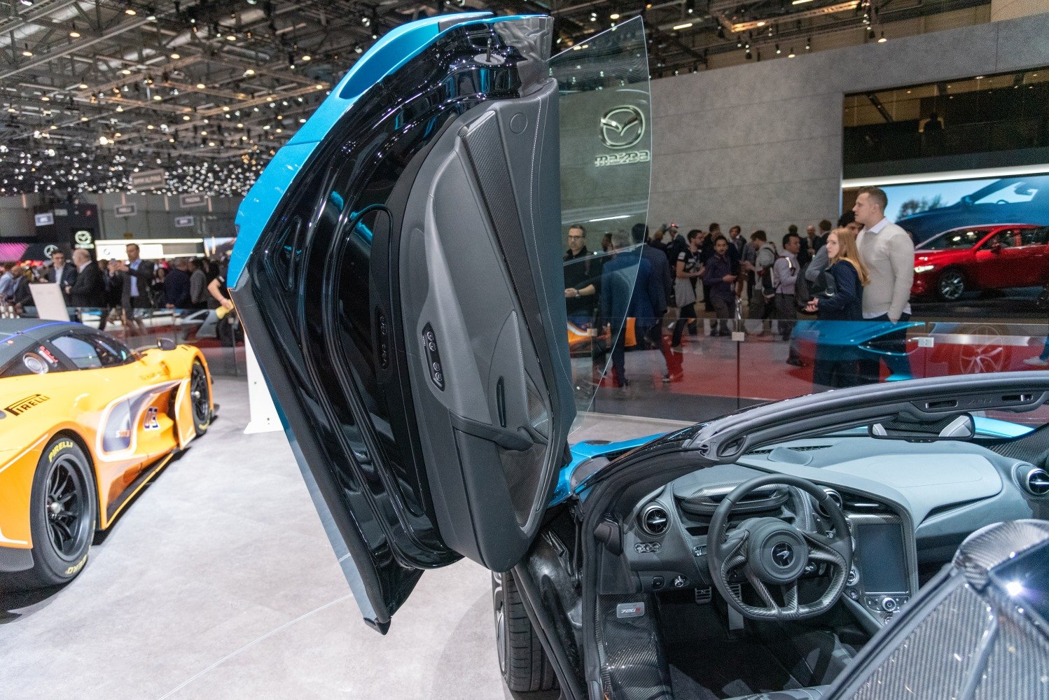 Butterfly door open revealing sports car interior and steering wheel
