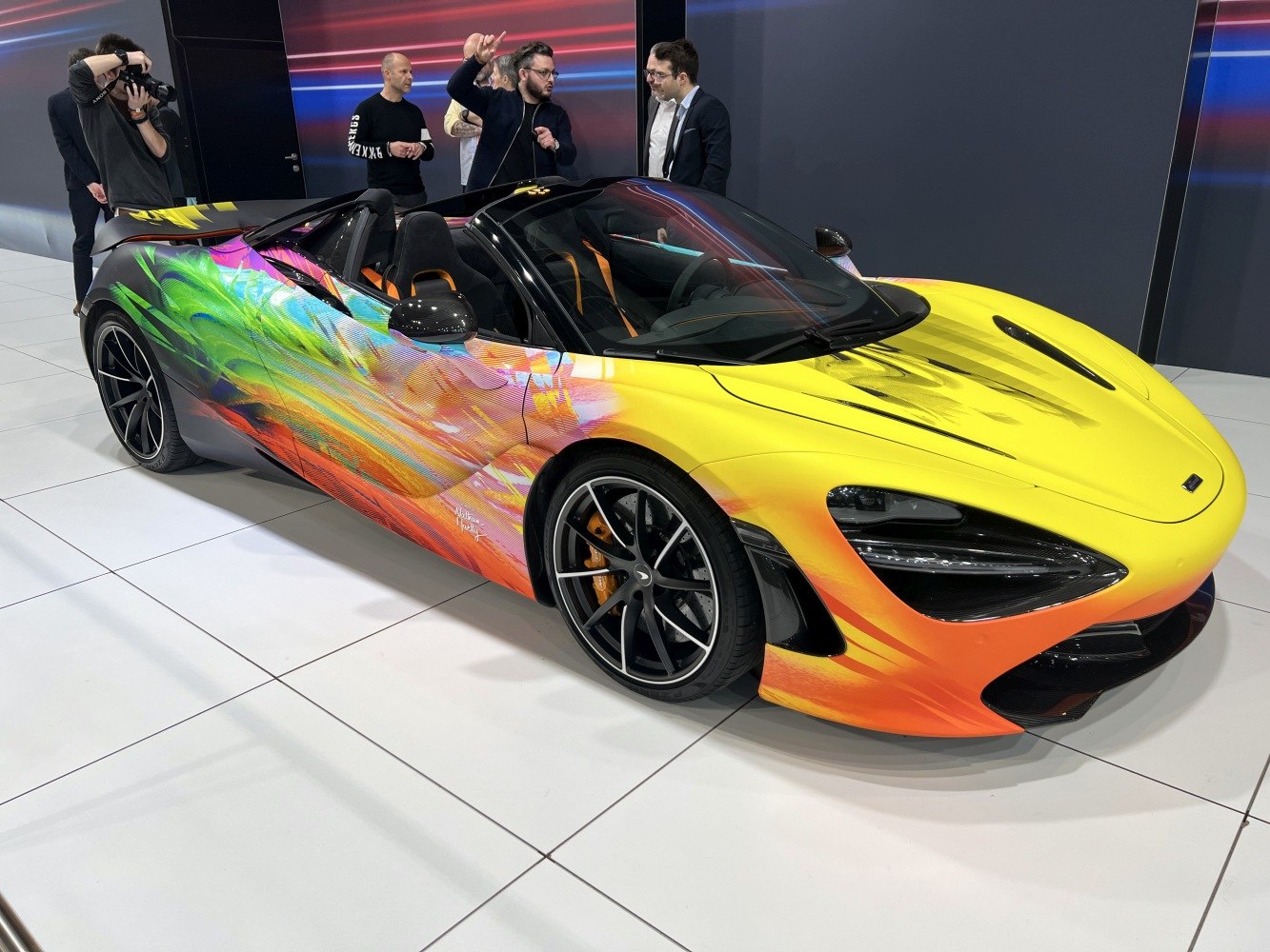 Convertible sports car with yellow-orange gradient and vivid artwork on the side