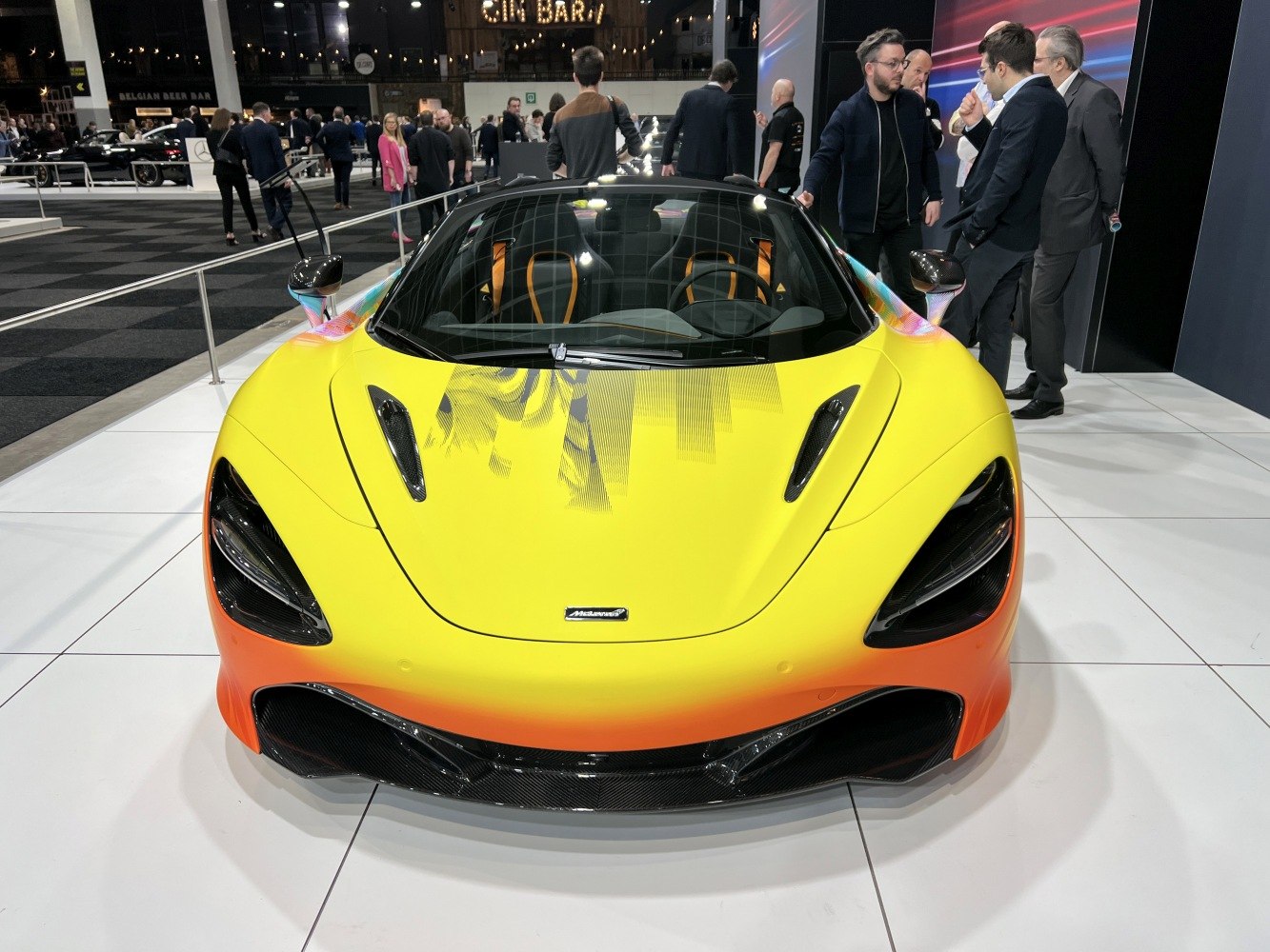 Front fascia with sleek headlights, carbon fiber splitter, and aerodynamic vents.