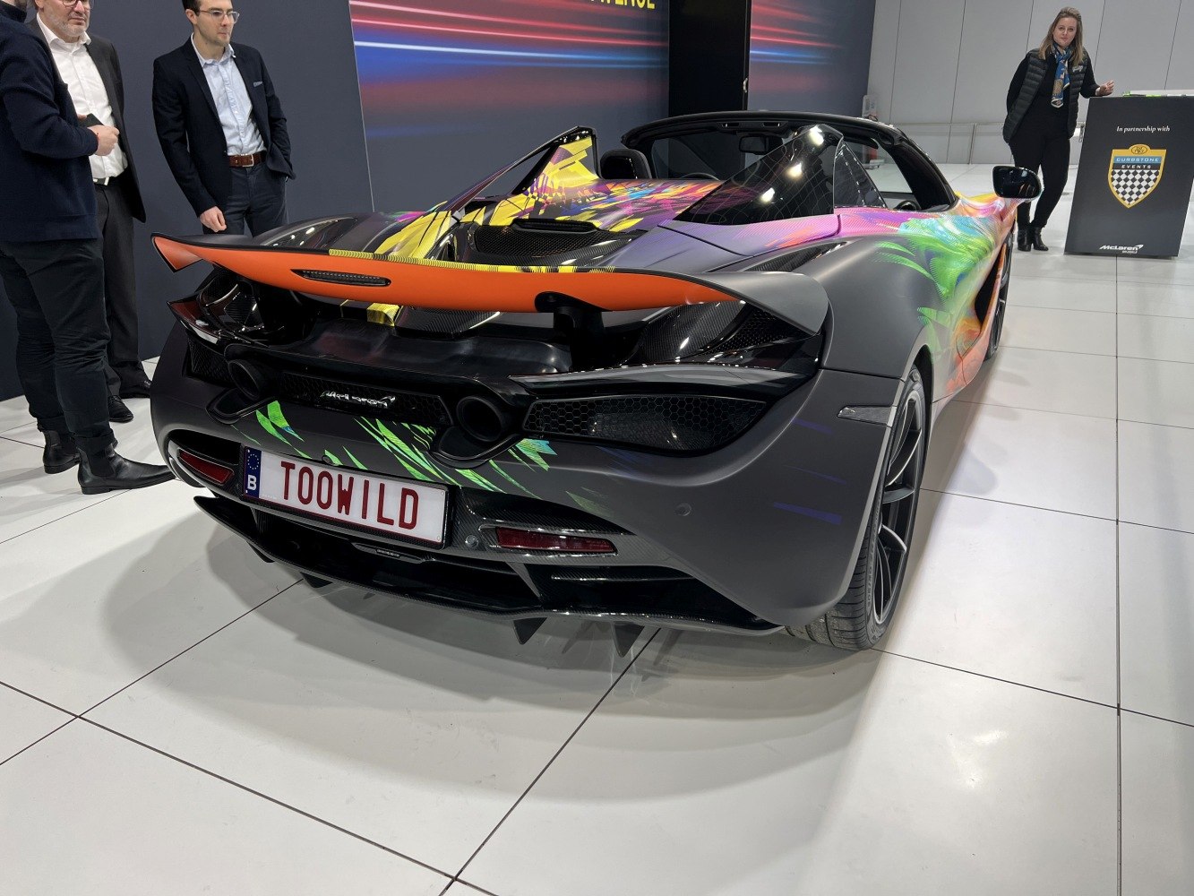 Rear end with custom colorful wrap and prominent spoiler
