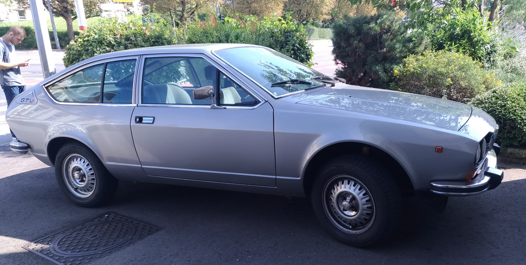 Silver vintage sporty coupe with classic side profile and wheel design