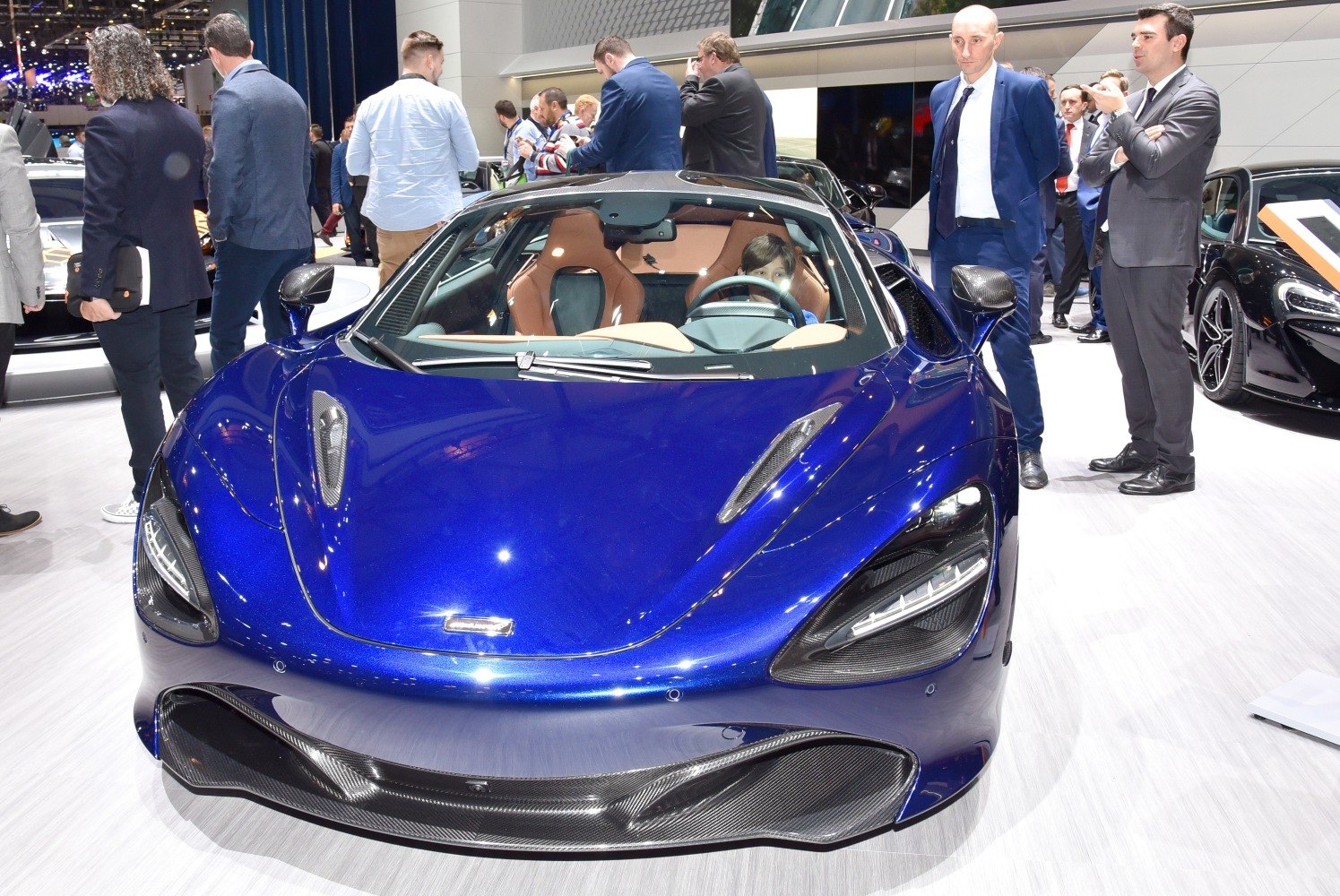 Aerodynamic front design and luxurious interior visible through windshield