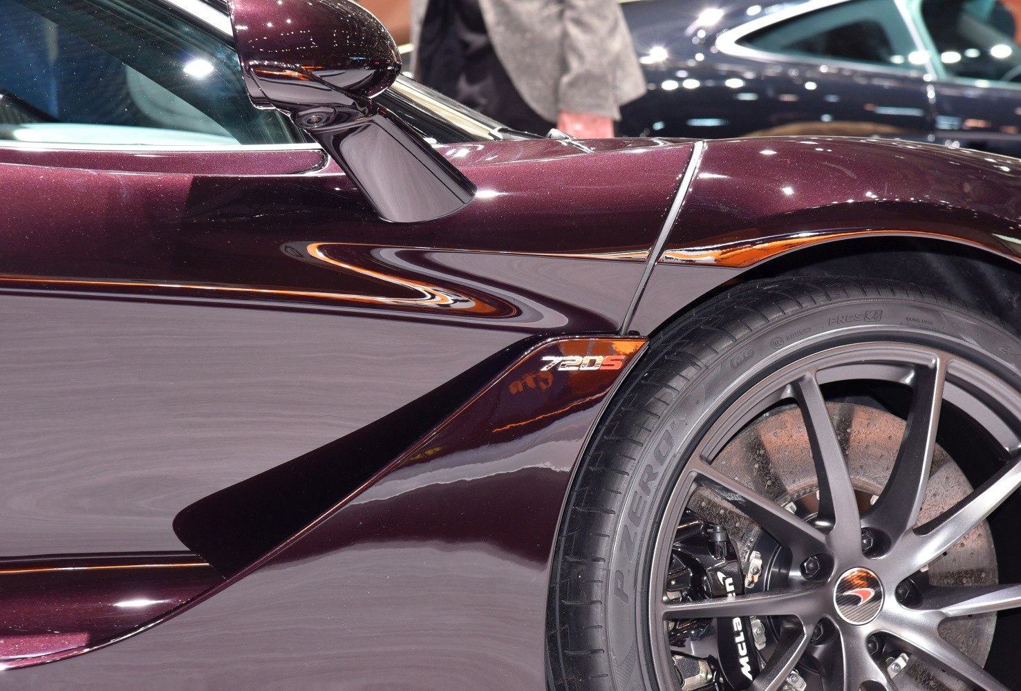 Close-up of sports car side panel and rear wheel with 720S badge.