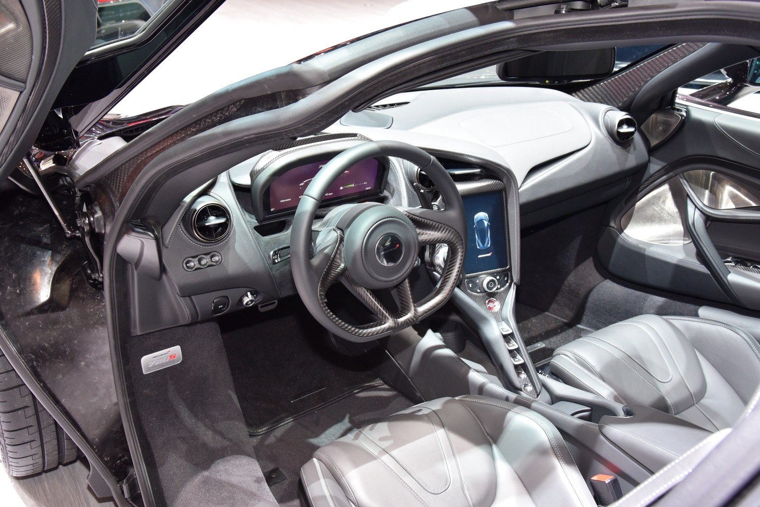 Carbon fiber steering wheel and digital dashboard in sports car interior