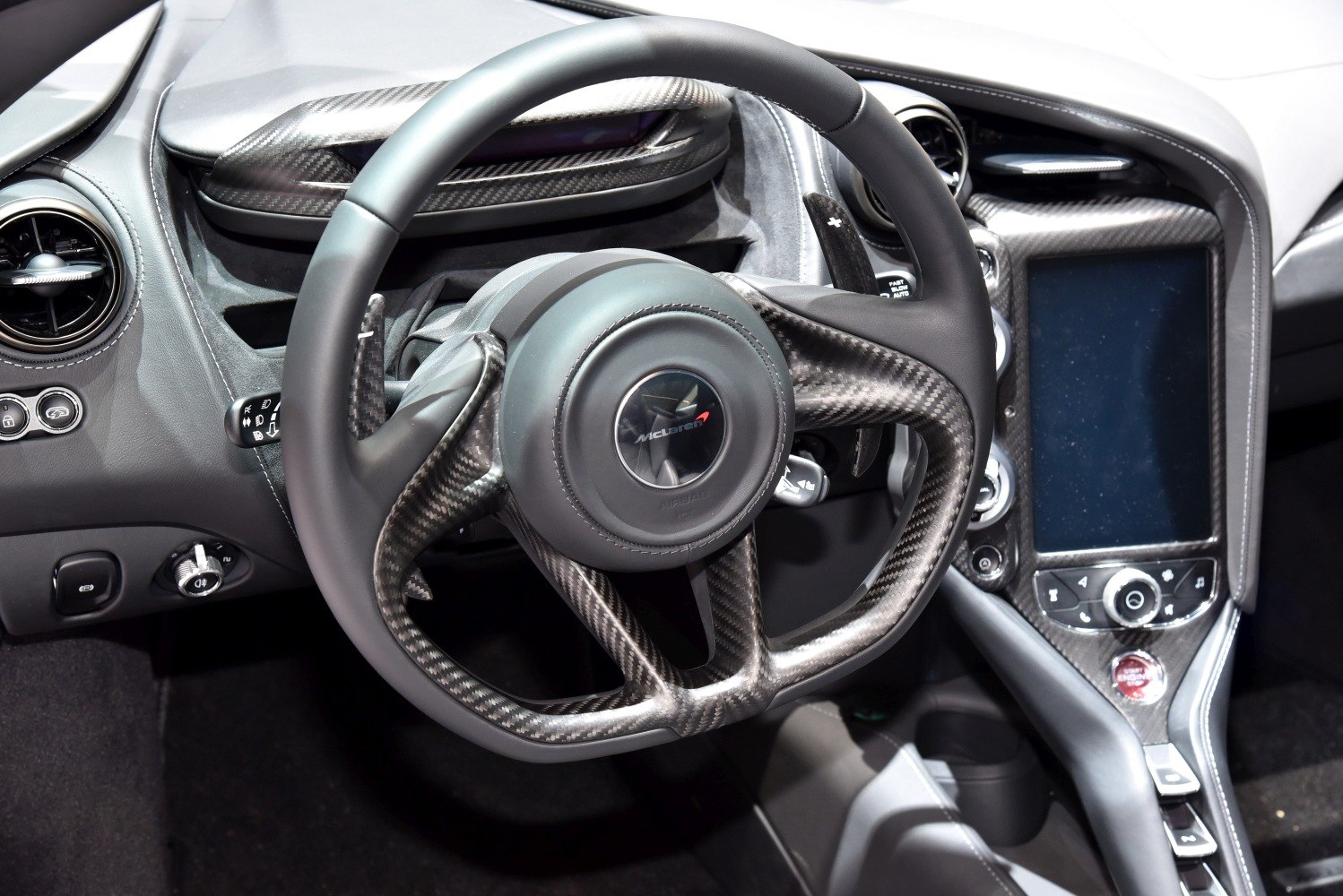 Carbon fiber steering wheel and center console with motorsport design elements
