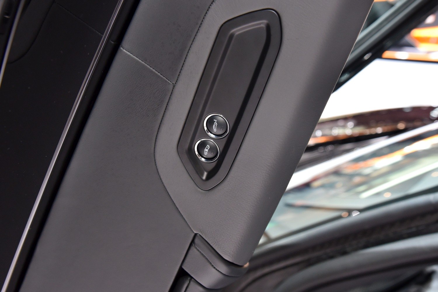 Close-up of car interior door controls with buttons