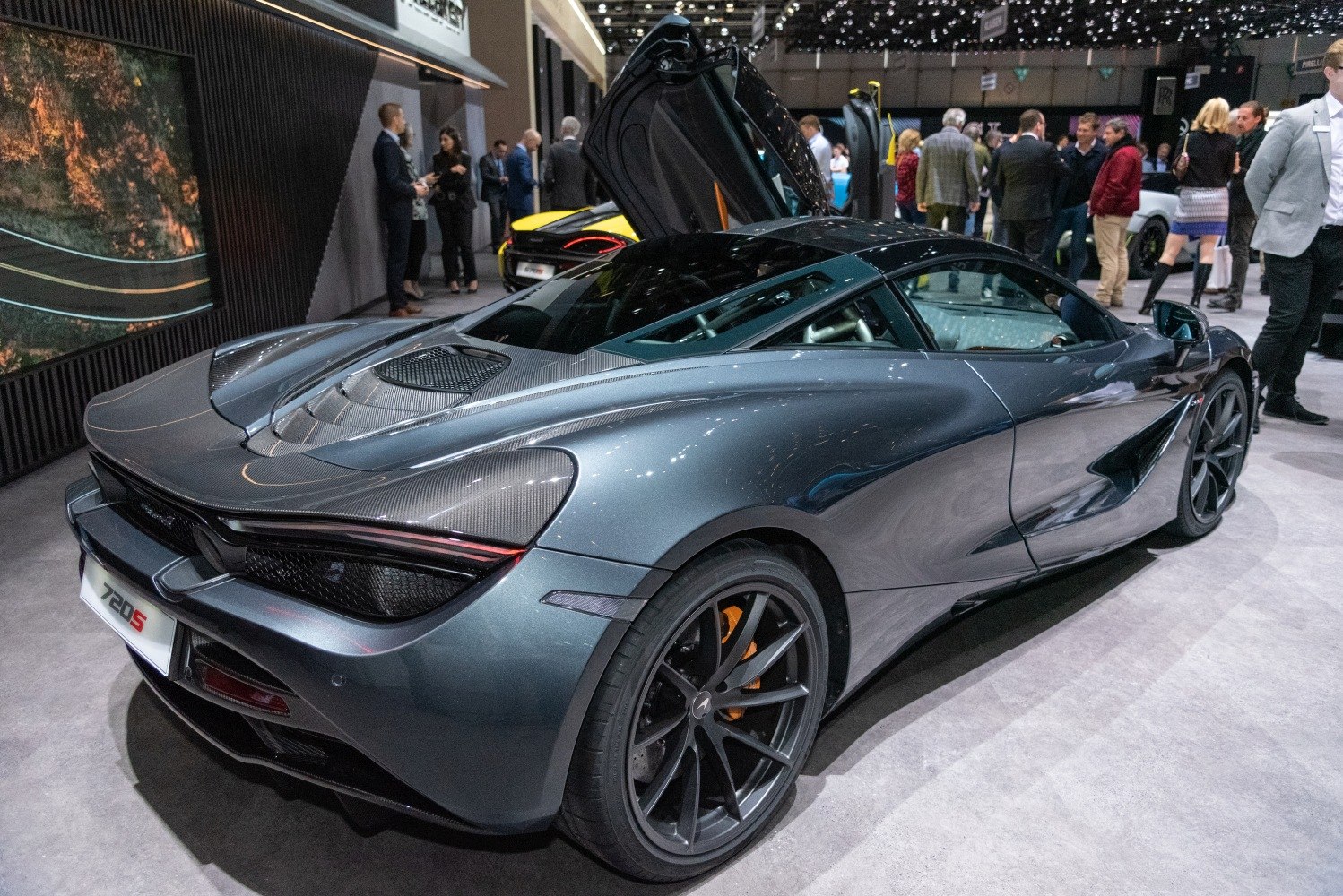 Rear aerodynamic design with butterfly doors and carbon fiber details