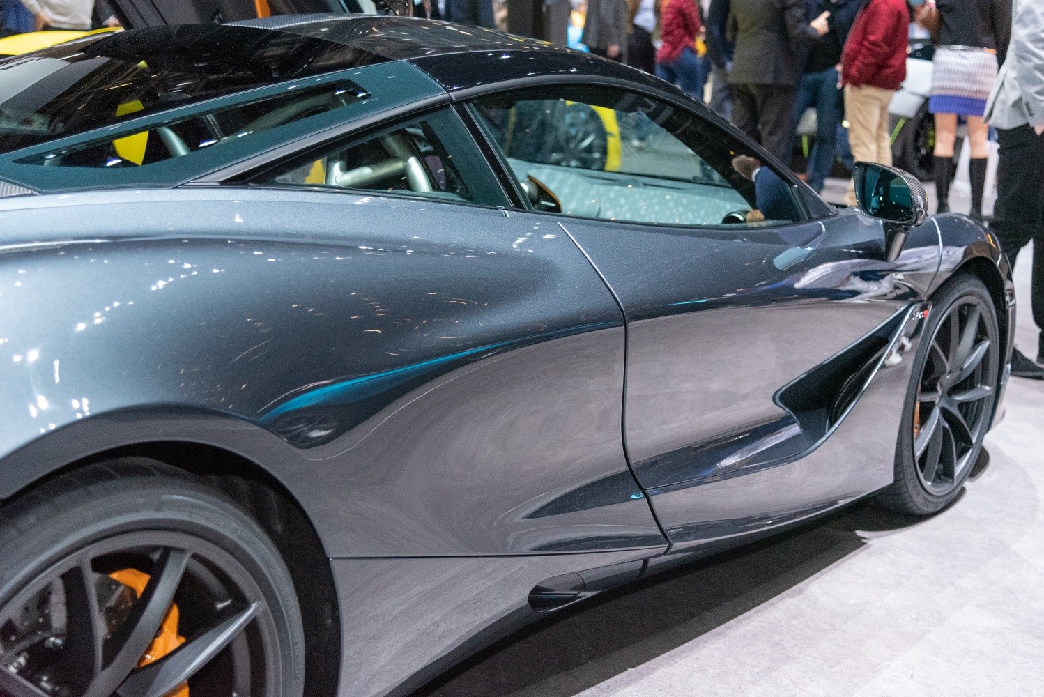 Sleek aerodynamic side profile with air intakes and stylized alloy wheels.