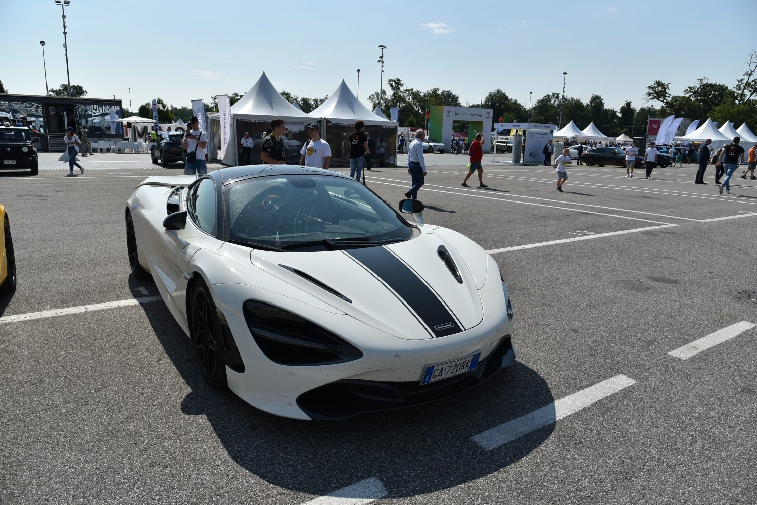 White sports coupe front with black racing stripe and aerodynamic design