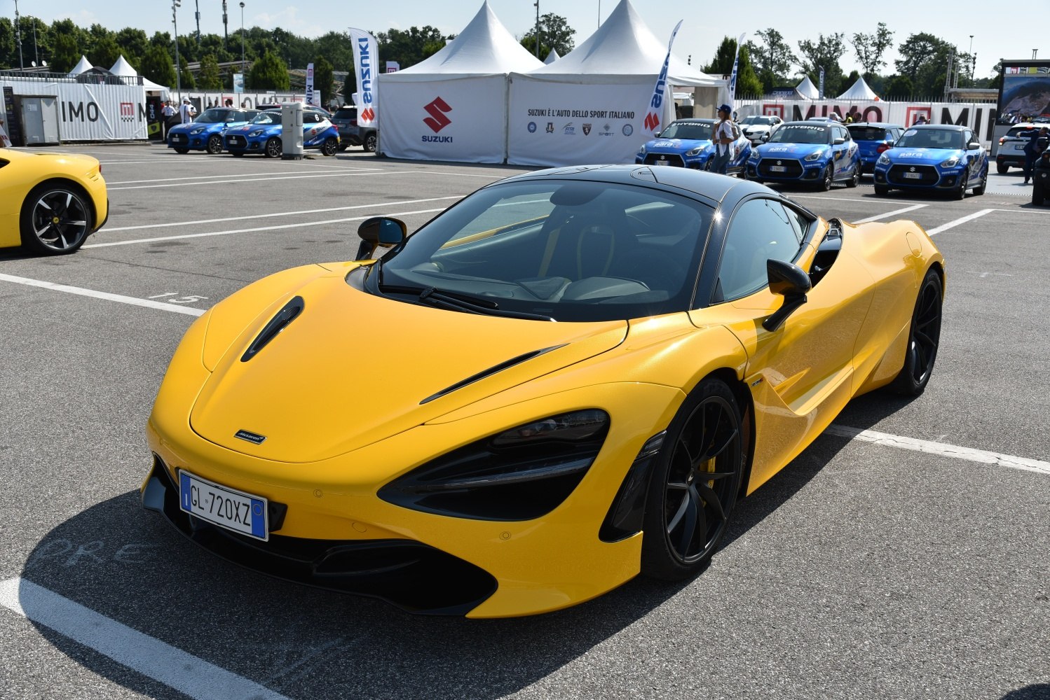 Yellow supercar with sleek aerodynamic body and black roof