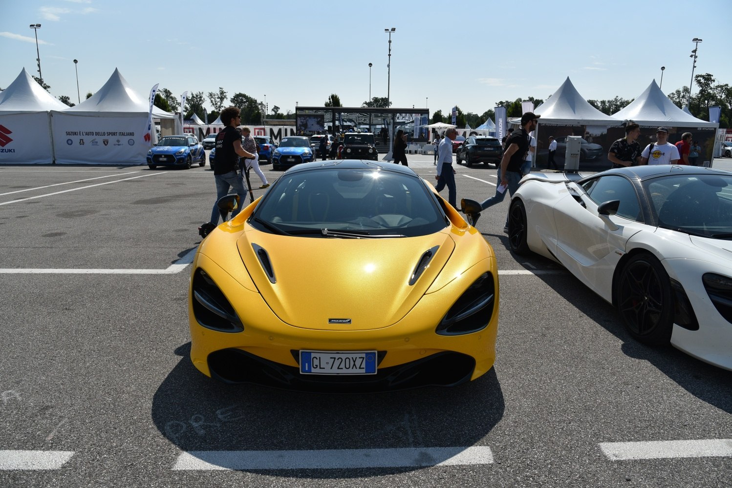Distinctive sharp front with large air intakes and sleek headlights on a yellow sports car.