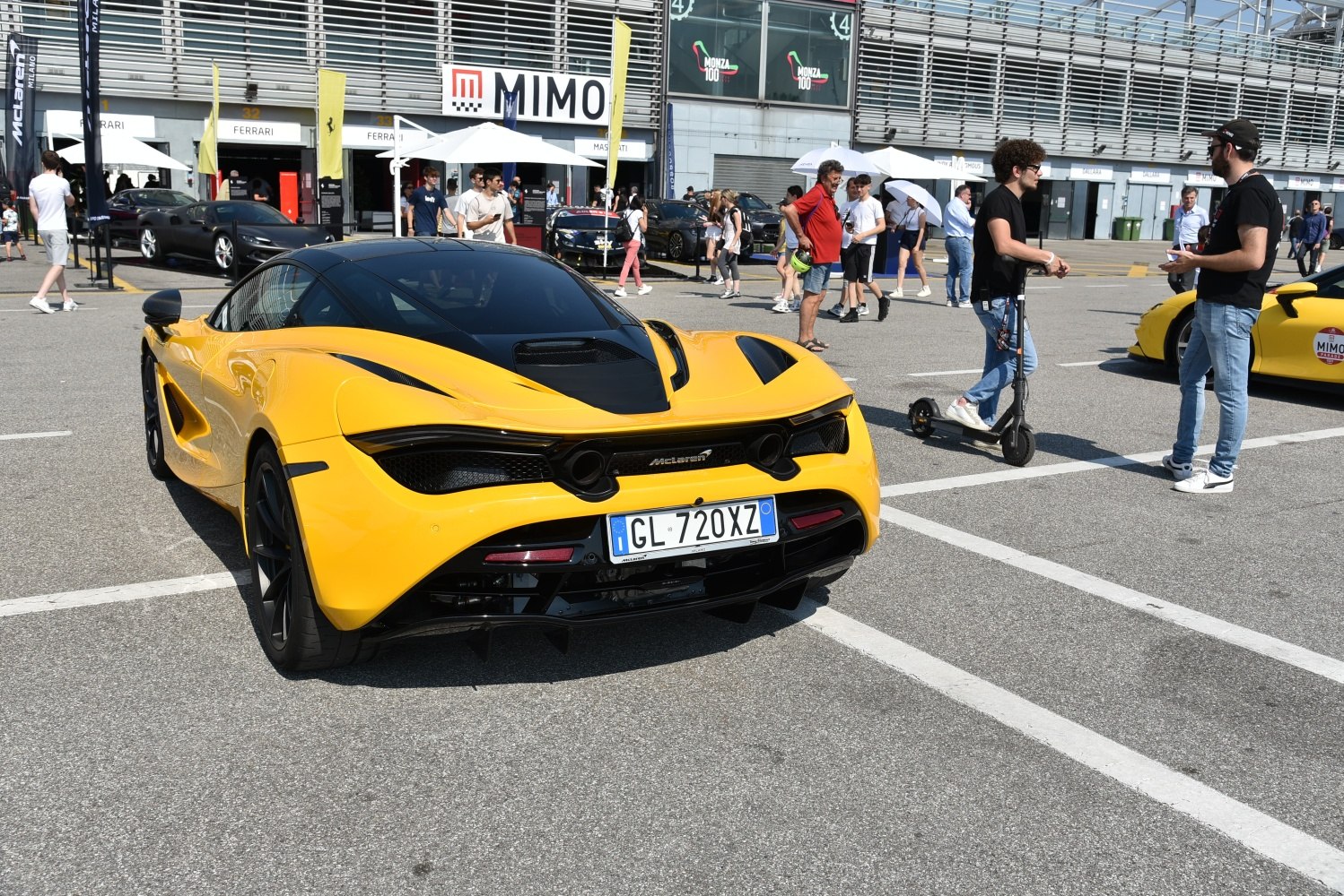 Yellow sports coupe with sleek rear design and aerodynamic features.