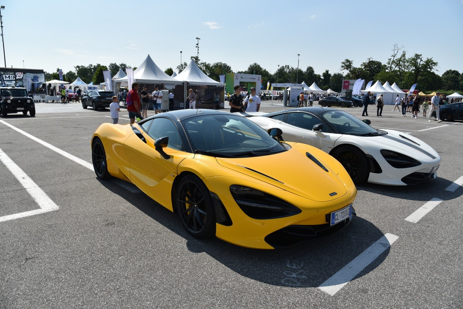 Two aerodynamic McLaren 720S sports cars in yellow and white