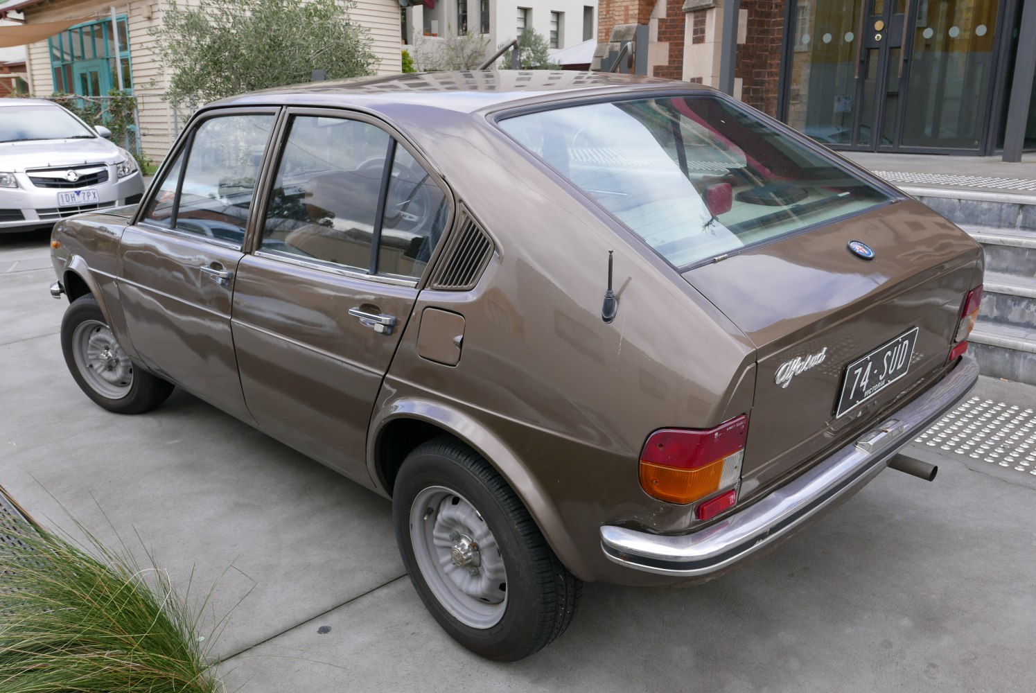 Vintage hatchback rear-side with unique side vents and classic wheels