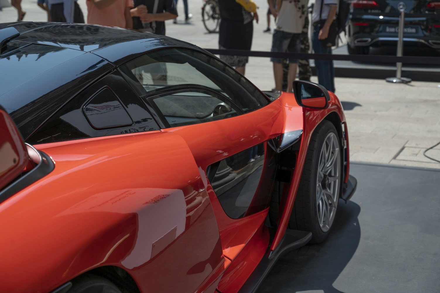 Side profile showing sleek aerodynamic design and rear wheel of sports car