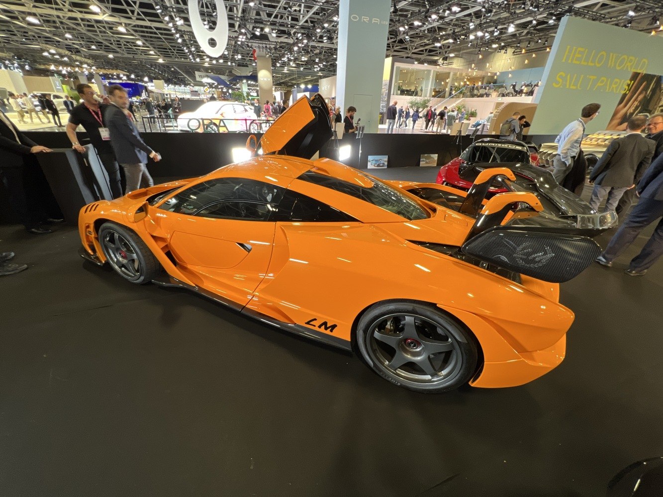 Aerodynamic orange supercar with large rear wing and sporty design