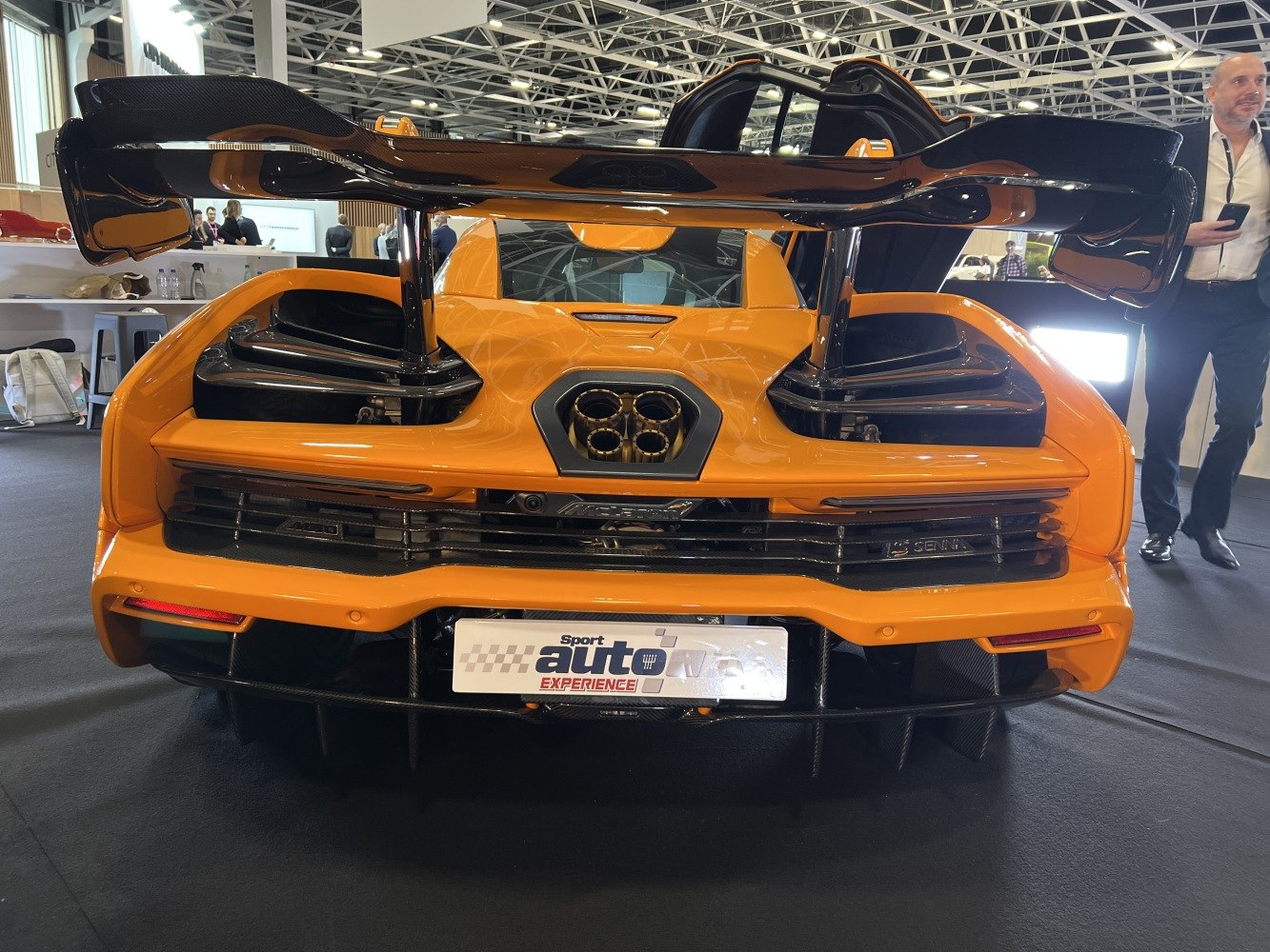 Rear view with large aerodynamic wing and quad central exhaust pipes