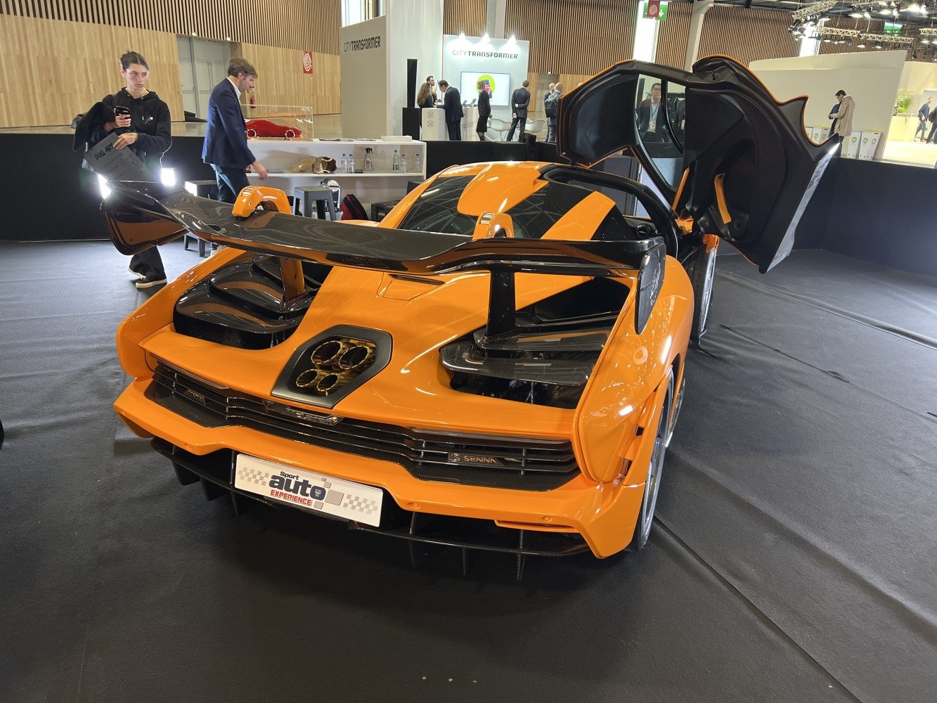 Rear view with large carbon fiber wing and butterfly doors open