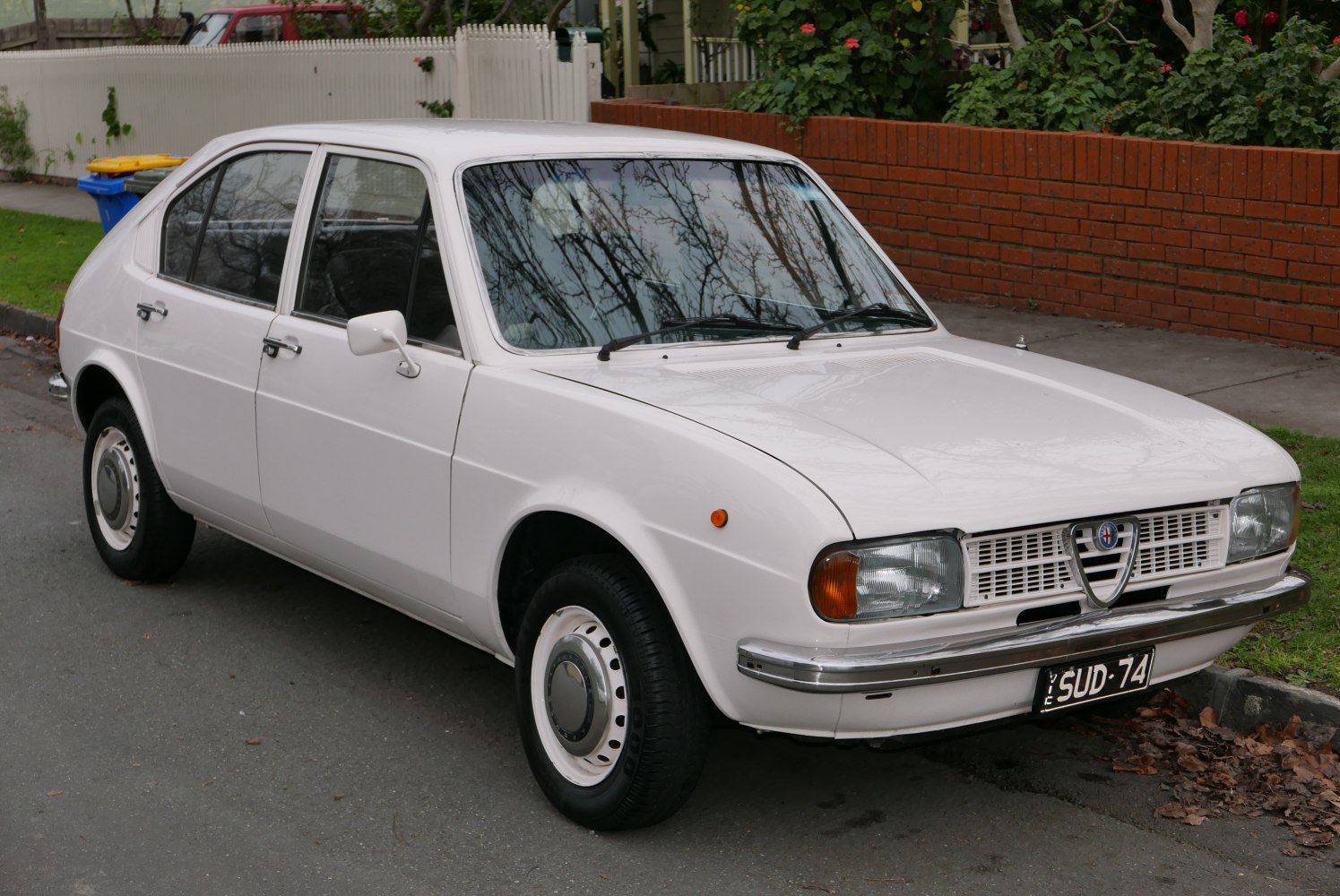 1970s vintage hatchback with round headlights and chrome bumpers