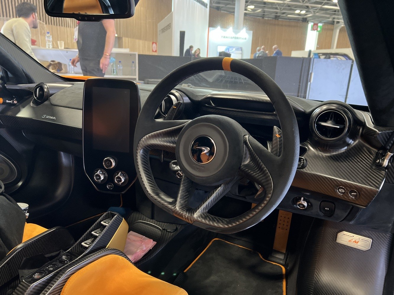Carbon fiber steering wheel with digital touchscreen dashboard and sporty interior trim