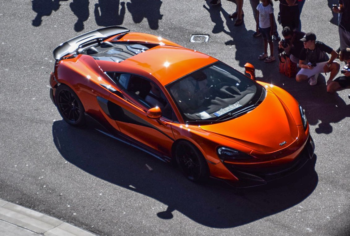 Orange sports coupe with aerodynamic rear wing and sleek black detailing