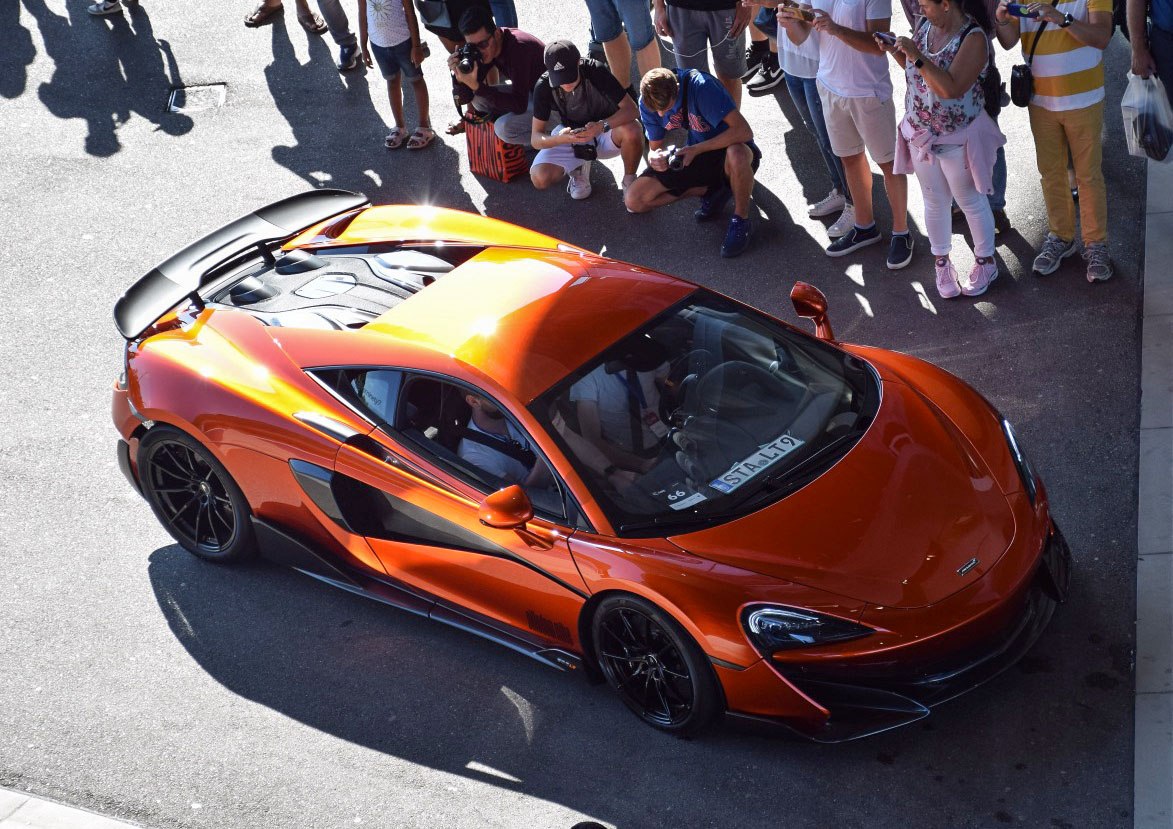 Orange sports car with carbon fiber rear spoiler and aerodynamic body