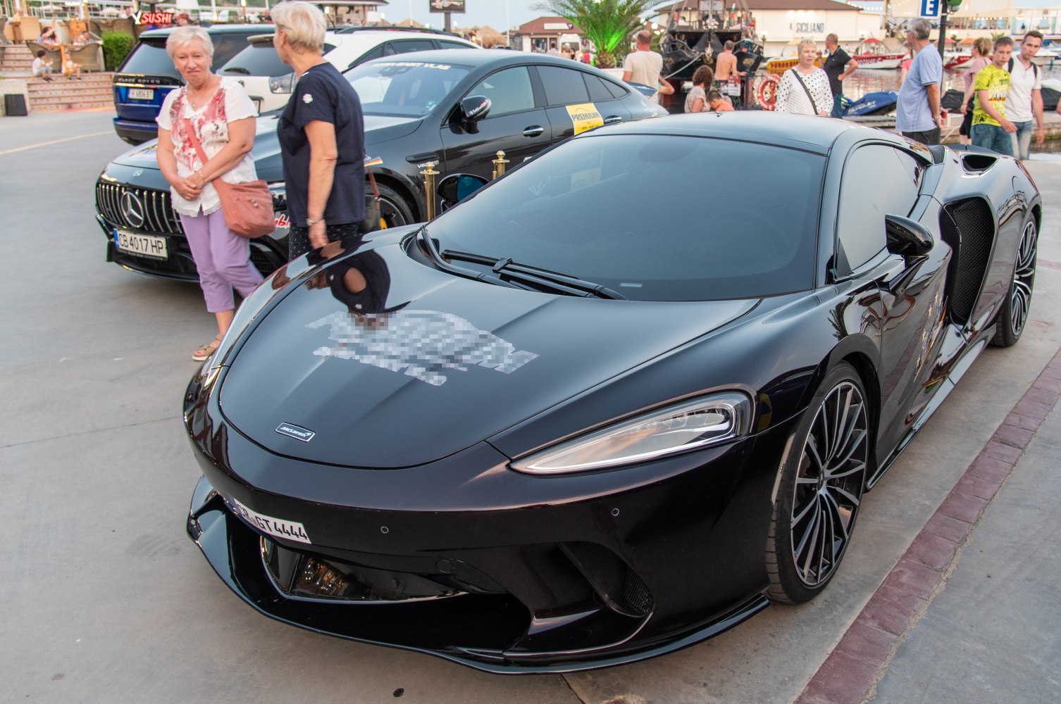 Sleek black McLaren GT front with aerodynamic design and alloy wheels