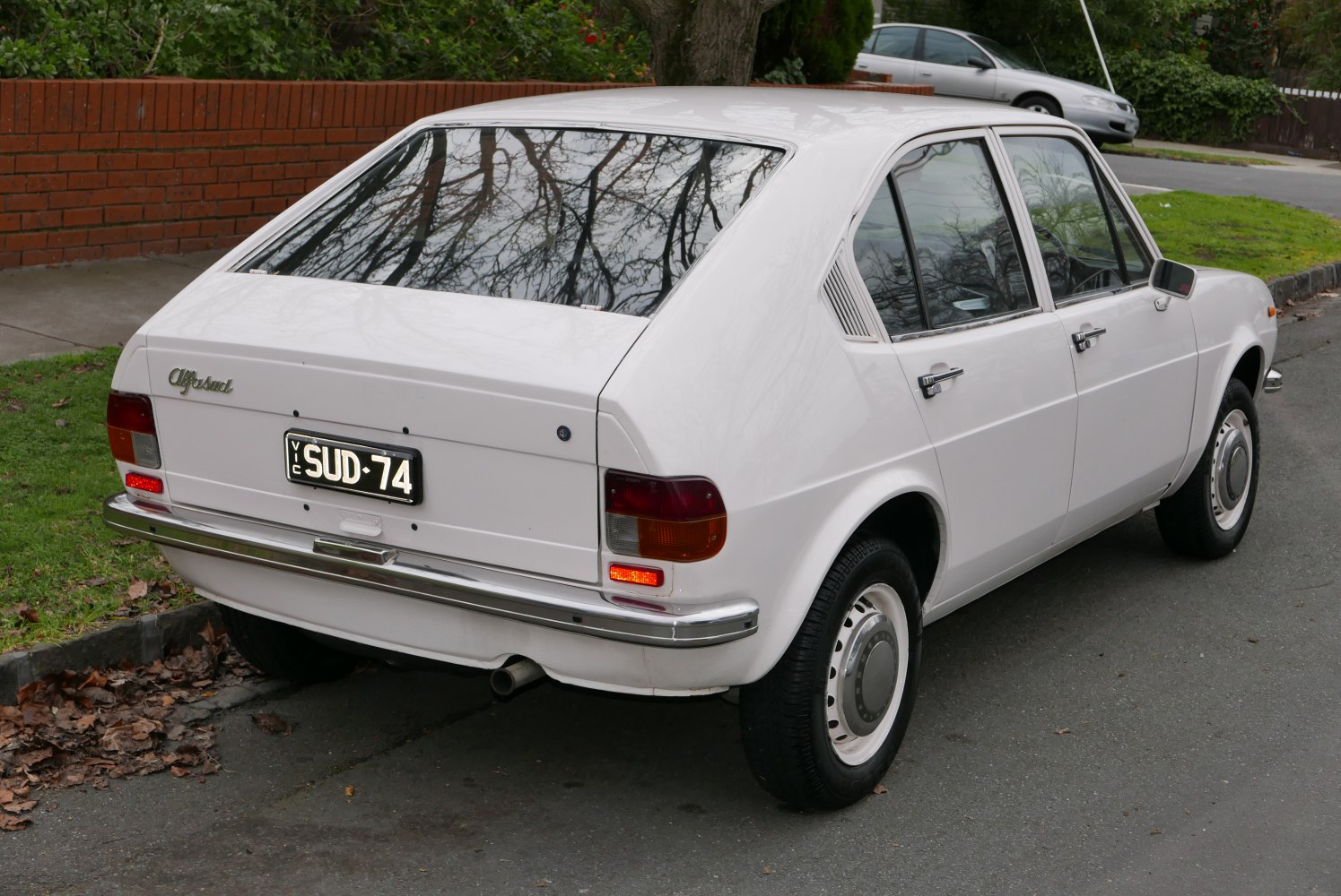Rear three-quarter view of vintage compact hatchback with chrome bumper