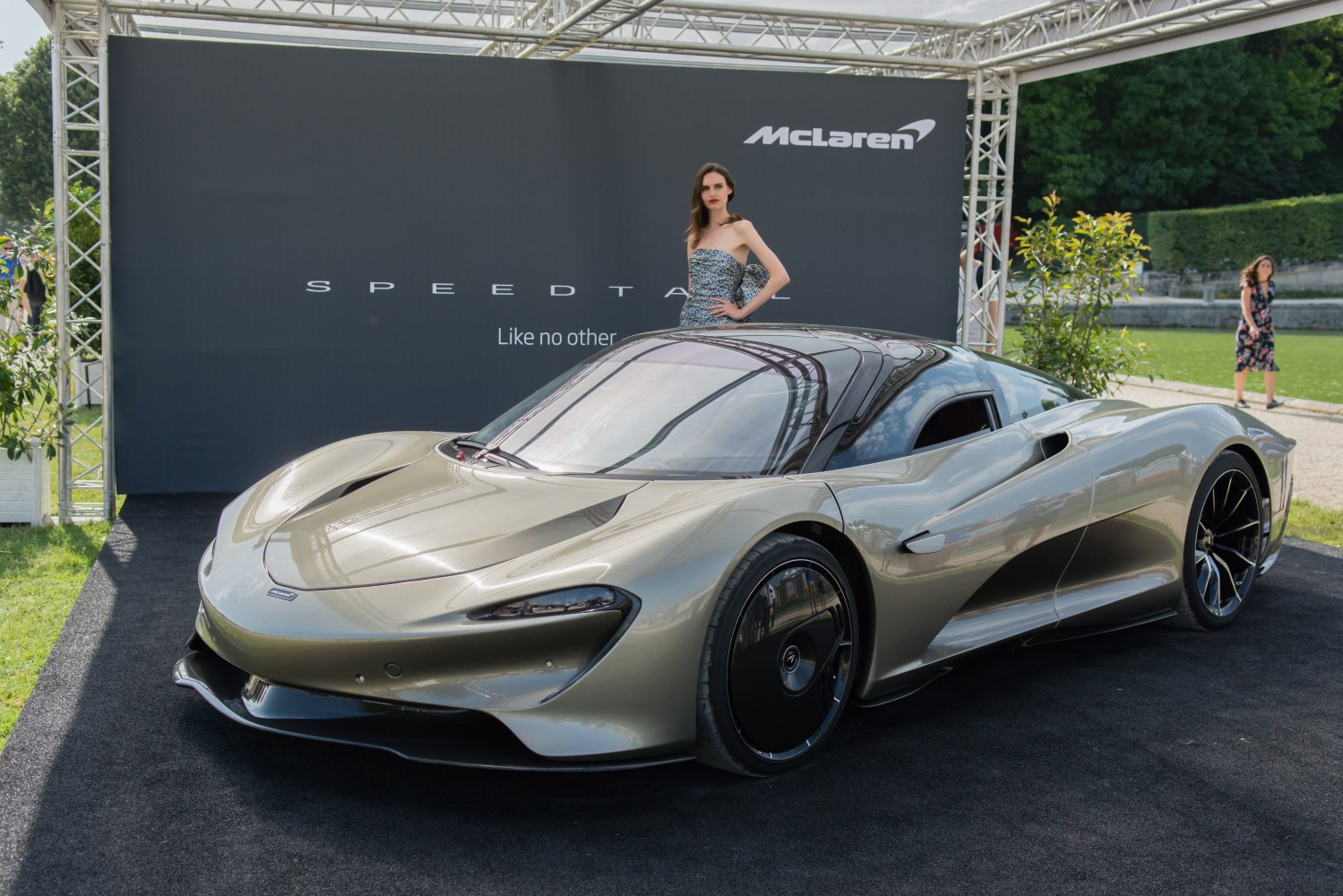 Sleek, aerodynamic hybrid hypercar with unique wheel covers and streamlined body.