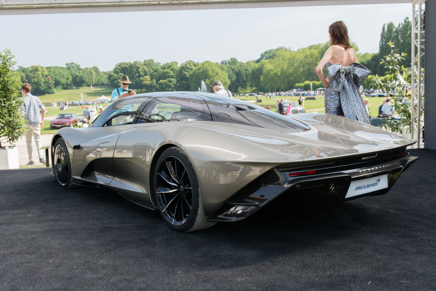 Sleek aerodynamic rear design with black wheels and glass roof