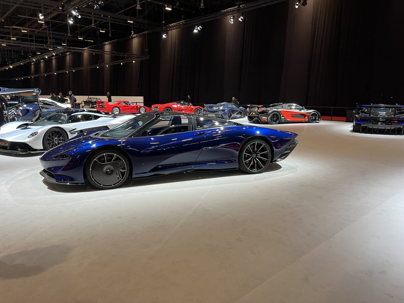Side profile of a sleek supercar with futuristic rear wheels and aerodynamic lines