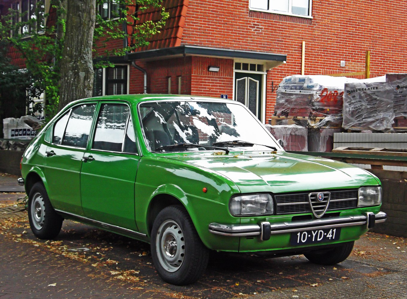 Vintage green vehicle with classic front grille and rectangular headlights