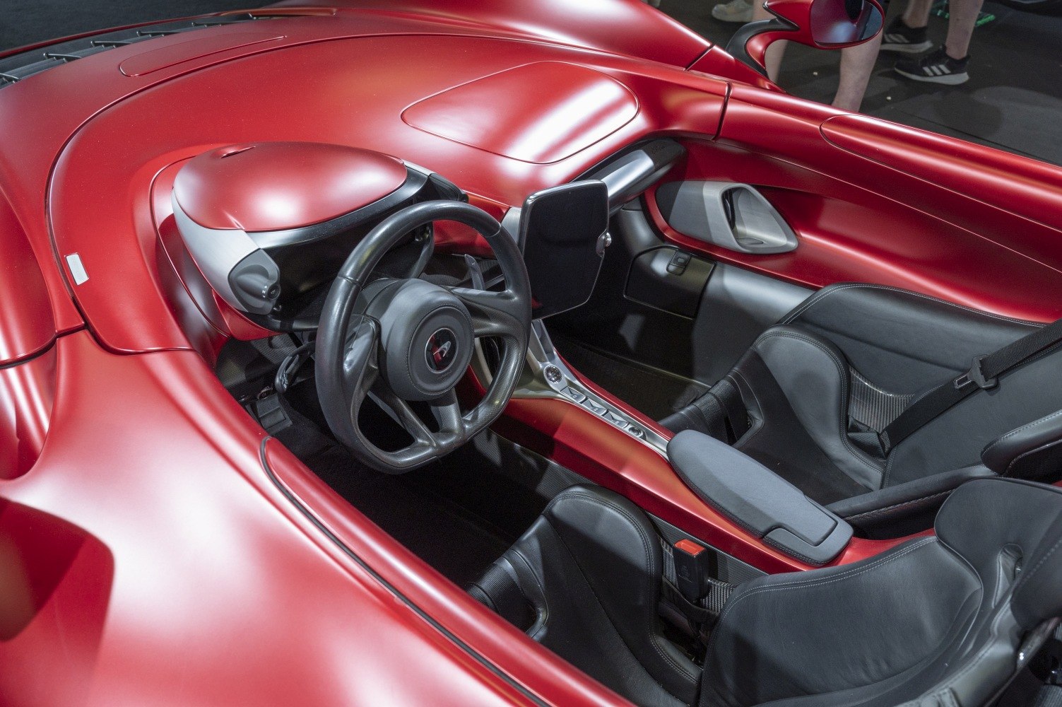 Sports car interior with black leather seats, steering wheel, dashboard