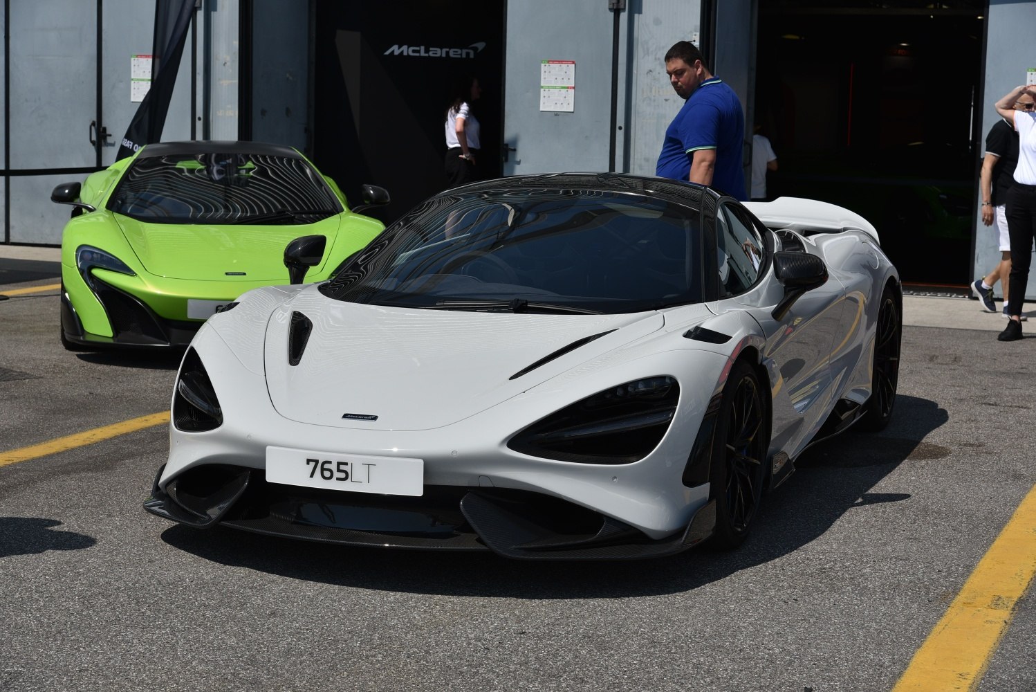 Aerodynamic front view with carbon fiber features and sleek headlights