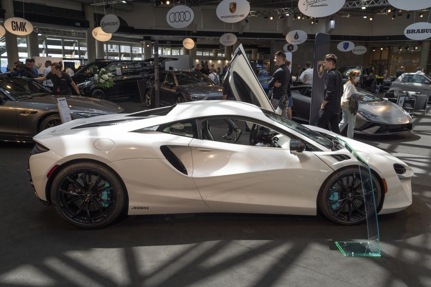 White sports coupe with butterfly doors and black alloy wheels