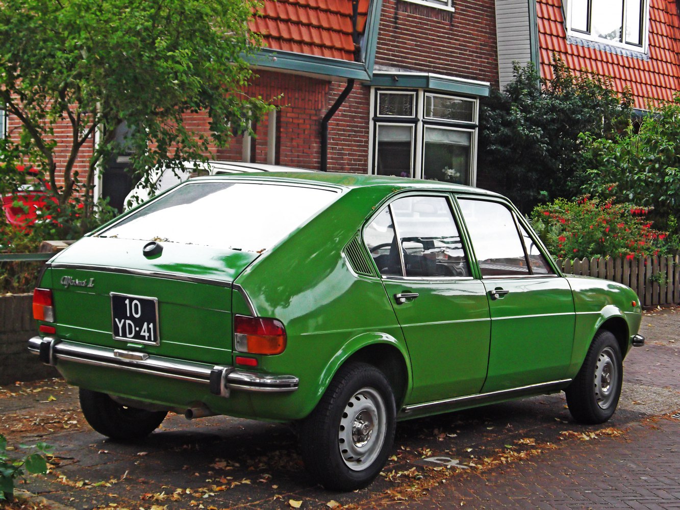 Green 1970s hatchback with rear side vents and chrome bumpers