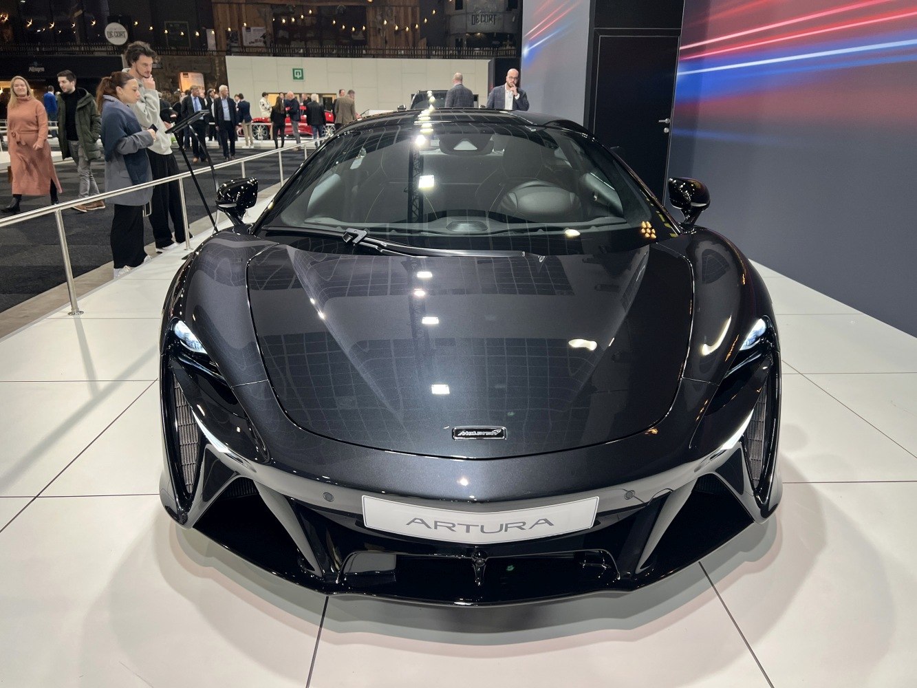 Front view of sleek 2021 supercar with aerodynamic design and sharp LED headlights