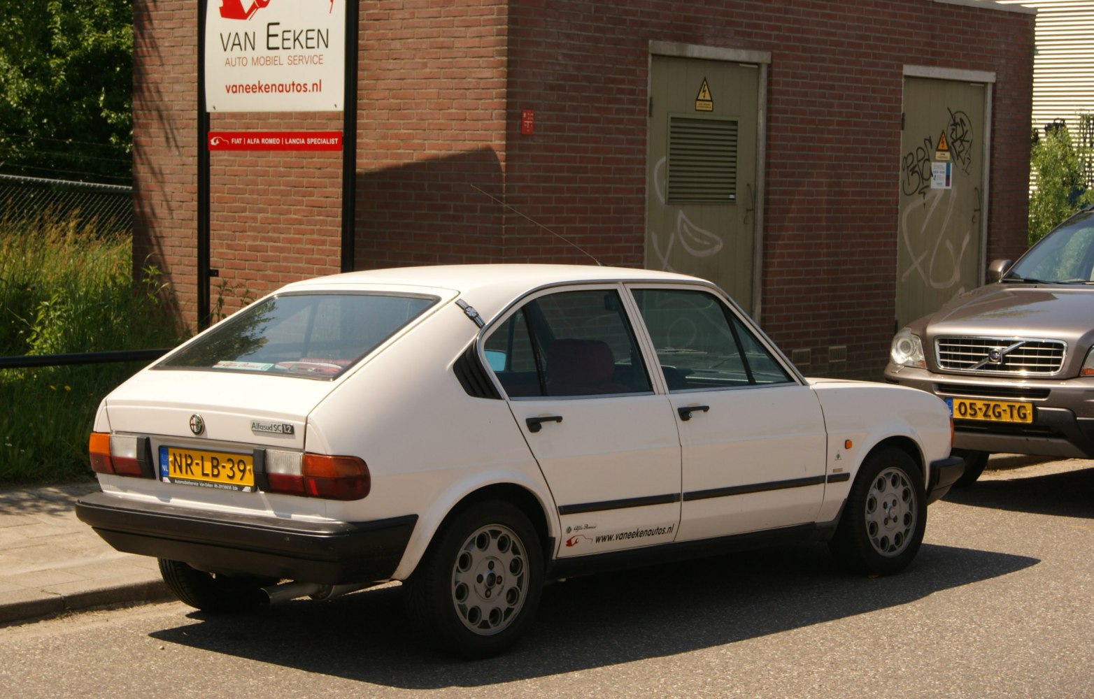 Rear side profile of vintage hatchback with round tail lamps and alloy wheels