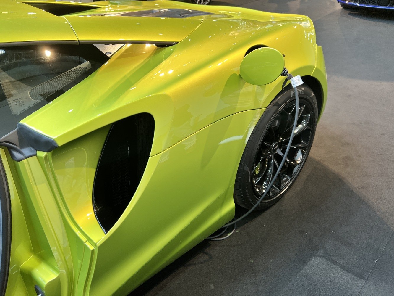 Rear side with charging port and black alloy wheel