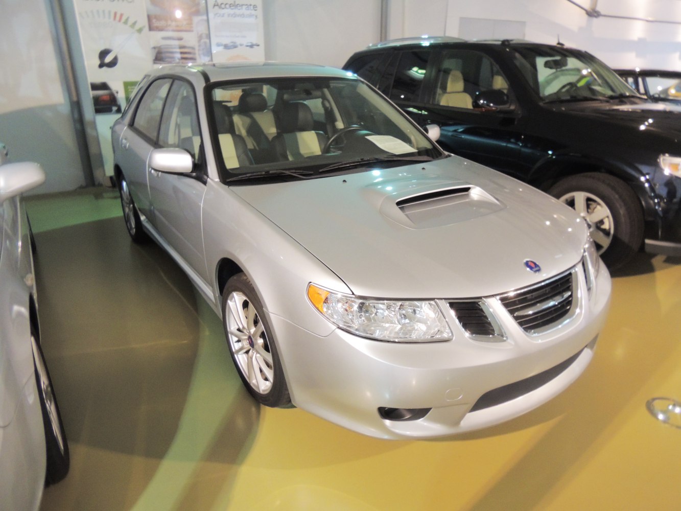 Silver sedan front with hood scoop and distinctive grille