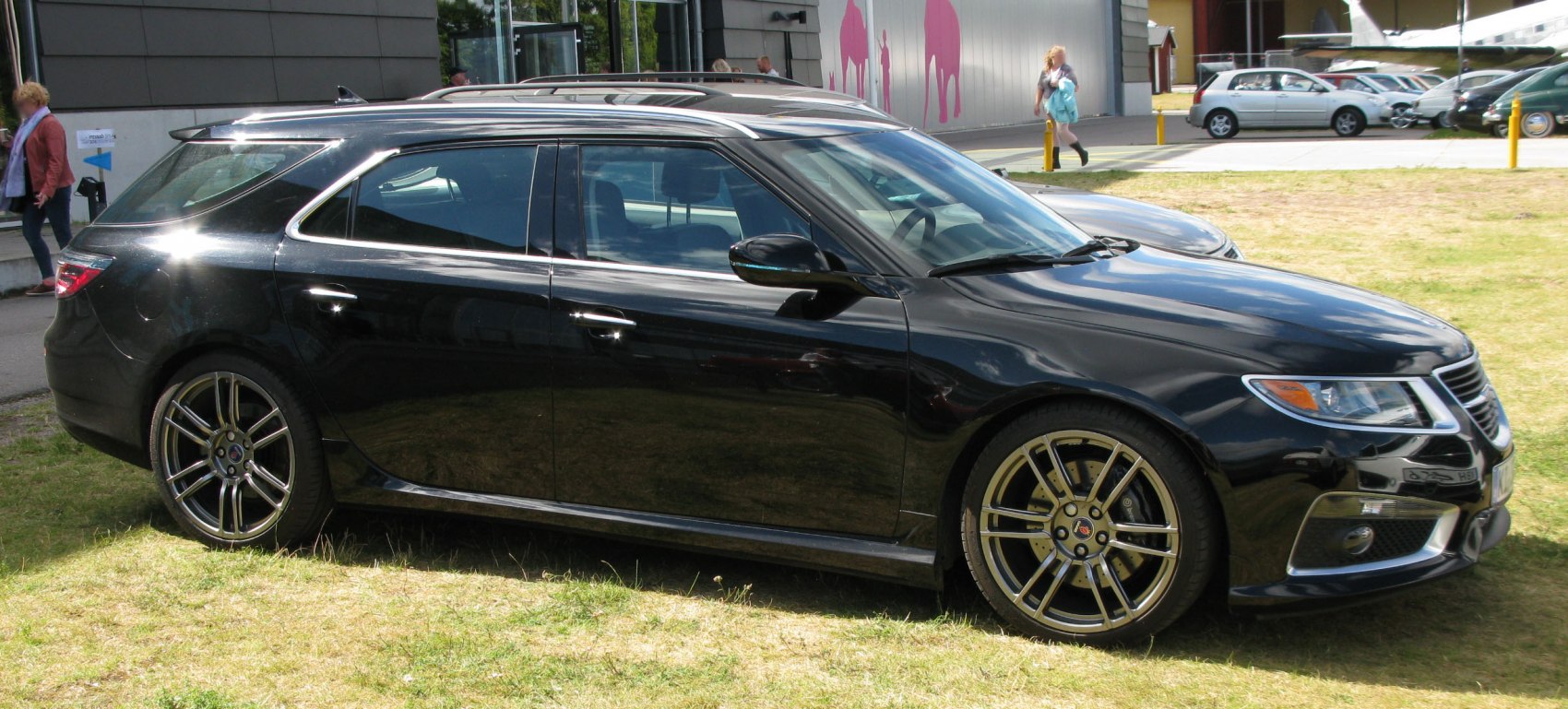 Black station wagon with sporty alloy wheels and elongated roofline
